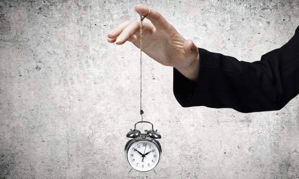 Close up of businessman holding clock on rope